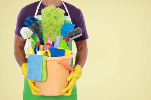 Cleaners working safely with protective equipment and safety signage