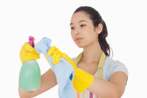 Office cleaning team sanitising desks in Lambeth